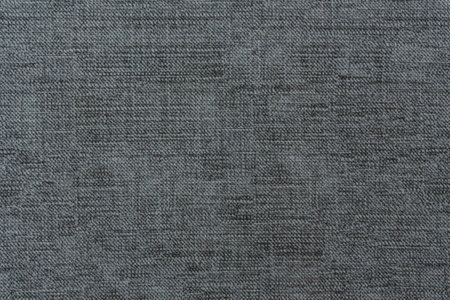 Detailed close-up view of dark gray woven fabric showing natural textile fibers and plain weave...