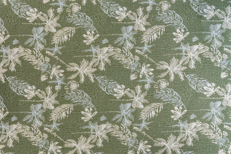 Medium-weight upholstery fabric texture in olive gray shade with tropical leaf pattern and lurex...
