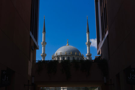A striking photo featuring the Nursetiye Mosque, built in 1823, with its distinctive dome and minarets, framed by the modern wallsの写真素材