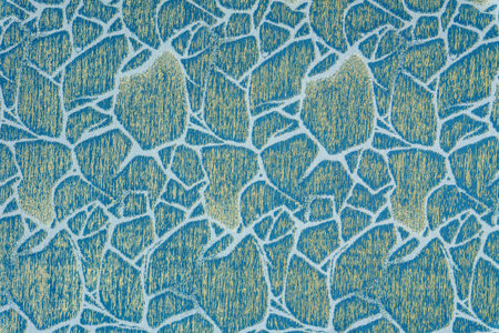 Bright sky blue fabric surface with a woven cracked ice ornament in gold. High-quality upholstery...