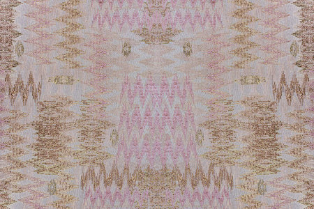 Delicate textile background with a pink and bronze abstract zig-zag pattern. High-quality jacquard...