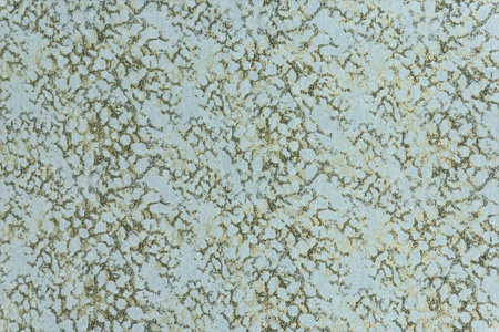 High-resolution macro of light blue textile with a golden branched pattern. Clean decorative...