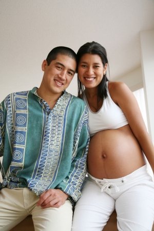 Pregnant couple smiling, posingの写真素材