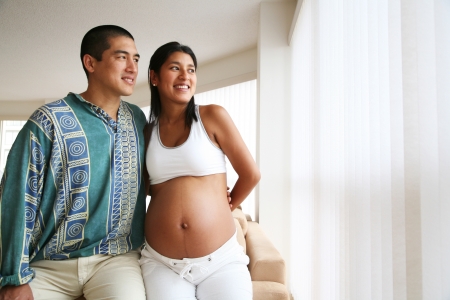 Pregnant couple smiling, posingの写真素材