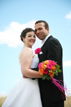 Bride and Groom against blue skyの写真素材