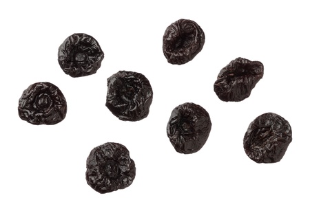Isolated dried plums over white background, close upの写真素材
