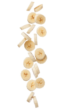 Falling banana slices isolated on white background, close upの写真素材