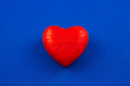 Red heart on a blu texture