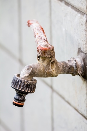 A rusty and old water tapの写真素材