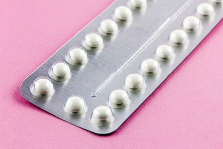 Birth control Pills on a pink backgroundの写真素材