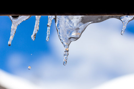 Ice stalactite pending with drop