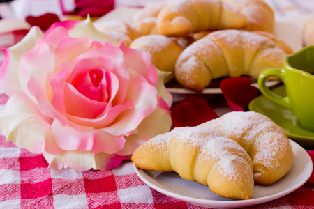 Breakfast croissant and coffee with flowerの写真素材