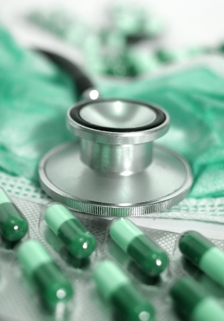 stethoscope and green capsulesの写真素材