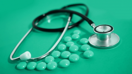 stethoscope and colored pills の写真素材