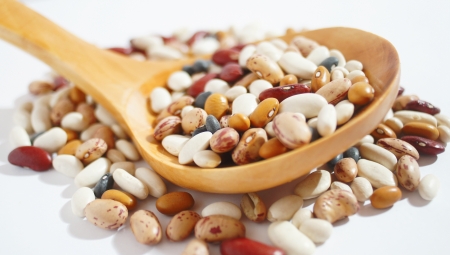 spilled raw colorful beans on white の写真素材