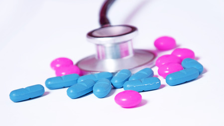 stethoscope and colored pills の写真素材