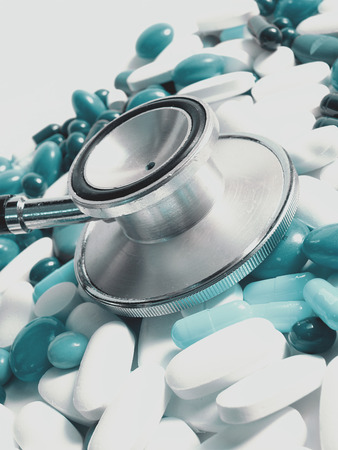 medical concept-stethoscope and colored pillsの写真素材