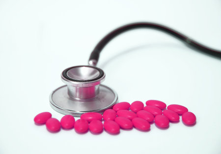 stethoscope and colored pillsの写真素材