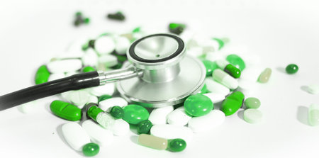 stethoscope and colored pillsの写真素材