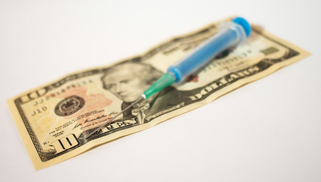 high costs of expensive medication concept - money,and injectionの写真素材