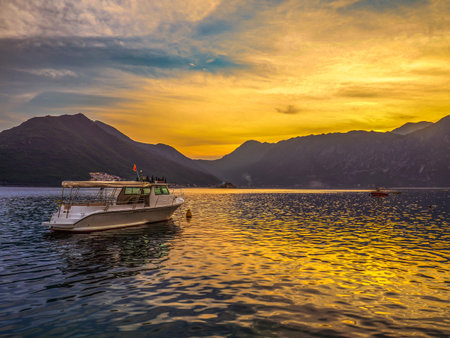 sunset on the sea in summertime and white boat