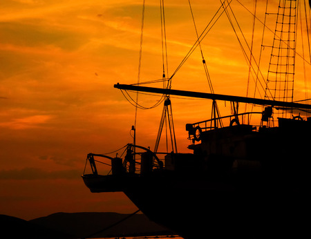 silhouette of the ship in sunsetの写真素材
