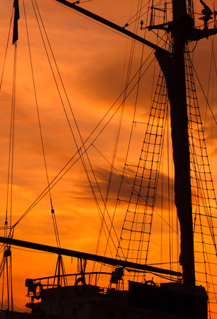 silhouette of Mast of the ship in sunsetの写真素材