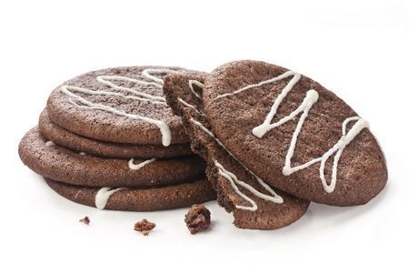 chocolate cookies on white background with white icing decorationの写真素材