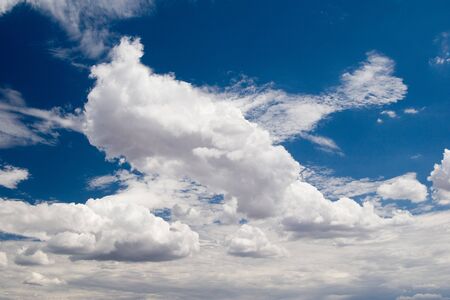 Fluffy clouds in the blue sky. Environment, atmosphere.  Perfect background imageの写真素材