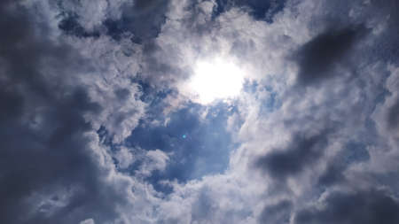 the afternoon shot where the sun is hiding behind the cloudsの写真素材