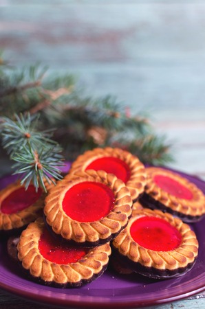 Christmas cookies. Cookies with raspberry jam on turicouse table background. Traditional Austrian biscuits filled.の写真素材