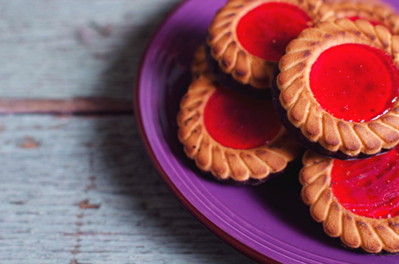 Christmas cookies. Cookies with raspberry jam on turicouse table background. Traditional Austrian biscuits filled. Soft focus.の写真素材