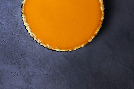 Fresh homemade pumpkin pie on dark stone background. Copy space. Top view.の写真素材