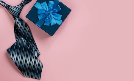Happy Father's day greeting card with decorated gift box and tie on pink background. Top view. Space for text.の写真素材