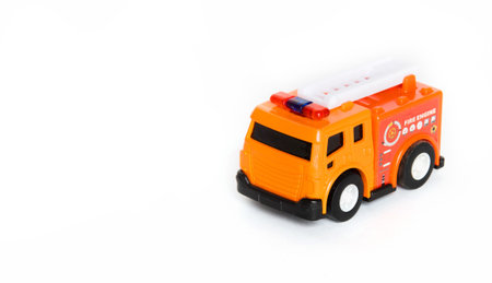 Red fire engine toy isolated over a white background