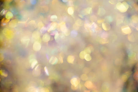 Abstract blurred gold background with beautiful bokeh effect.の写真素材