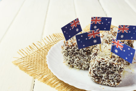 Iconic traditional Australian party food, Lamington cakes on a red, white and blue backgroundの写真素材