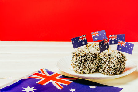 Iconic traditional Australian party food, Lamington cakes on a red, white and blue background.