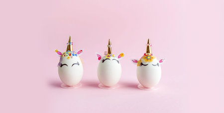 Unicorn eggs in the box isolated on pink background. Happy easter. Kids activity.
