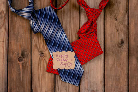 Happy Fathers Day red andblue ties on a rustic wood background.の写真素材