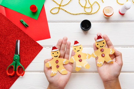 Application for kids. Christmas or New year card with gingerbread man from paper. DIY.の写真素材
