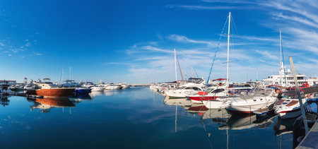Marine Station with yachts on the shore of the blue Black Sea in Sochi on a sunny day under the blue sky, white yachts.の写真素材