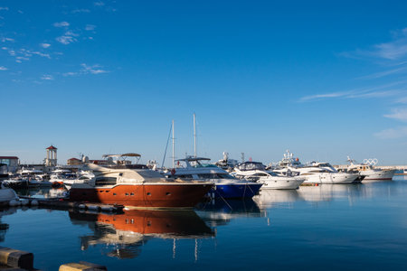 Marine Station with yachts on the shore of the blue Black Sea in Sochi on a sunny day under the blue sky, white yachts.の写真素材