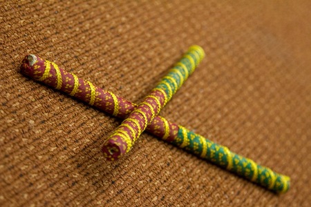 2 Dandiya sticks criss-crossed. Dandiya is the traditional folk dance of the state of Gujarat in India.の写真素材