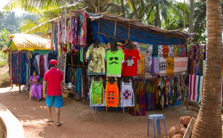 Goa, India - December 16, 2016: A local citizen selling clothes and accessories on the way to Anjuna beachのeditorial素材
