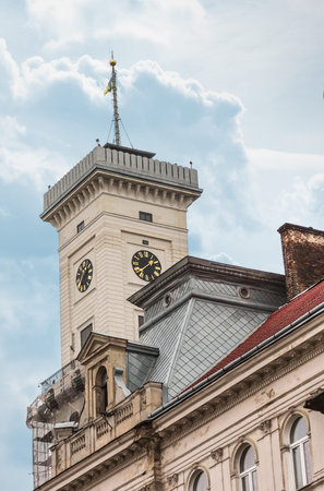Old Town Hall In Europe. Tower Clock Face With Roman Numerals And Arrows. Roofs Of Buildings In...