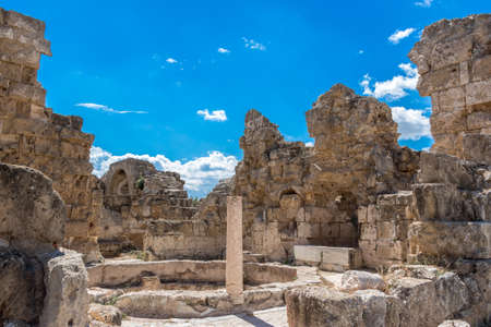 Ruins of the ancient greek city of Salamis. Medieval columns, wall and stones, historical architecture, tourist place, Cyprus, Famagusta. Clear blue sky with white clouds.の写真素材