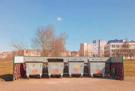 Garbage cans and garbage near them at special container sites in the courtyards of multi-storey buildings.の写真素材