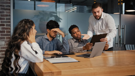 Business conflict quarrel misunderstanding. Multiracial angry businessmen and businesswoman arguing in office disputing confrontation at workplace aggressive multiethnic workers shouting discuss ideaの写真素材