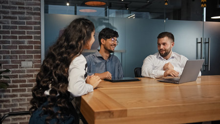 Three diverse business partners multiracial work group team developing new project multinational...